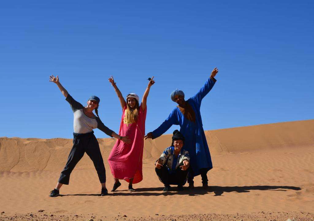 Tourists posing for a picture in the Sahara Desert