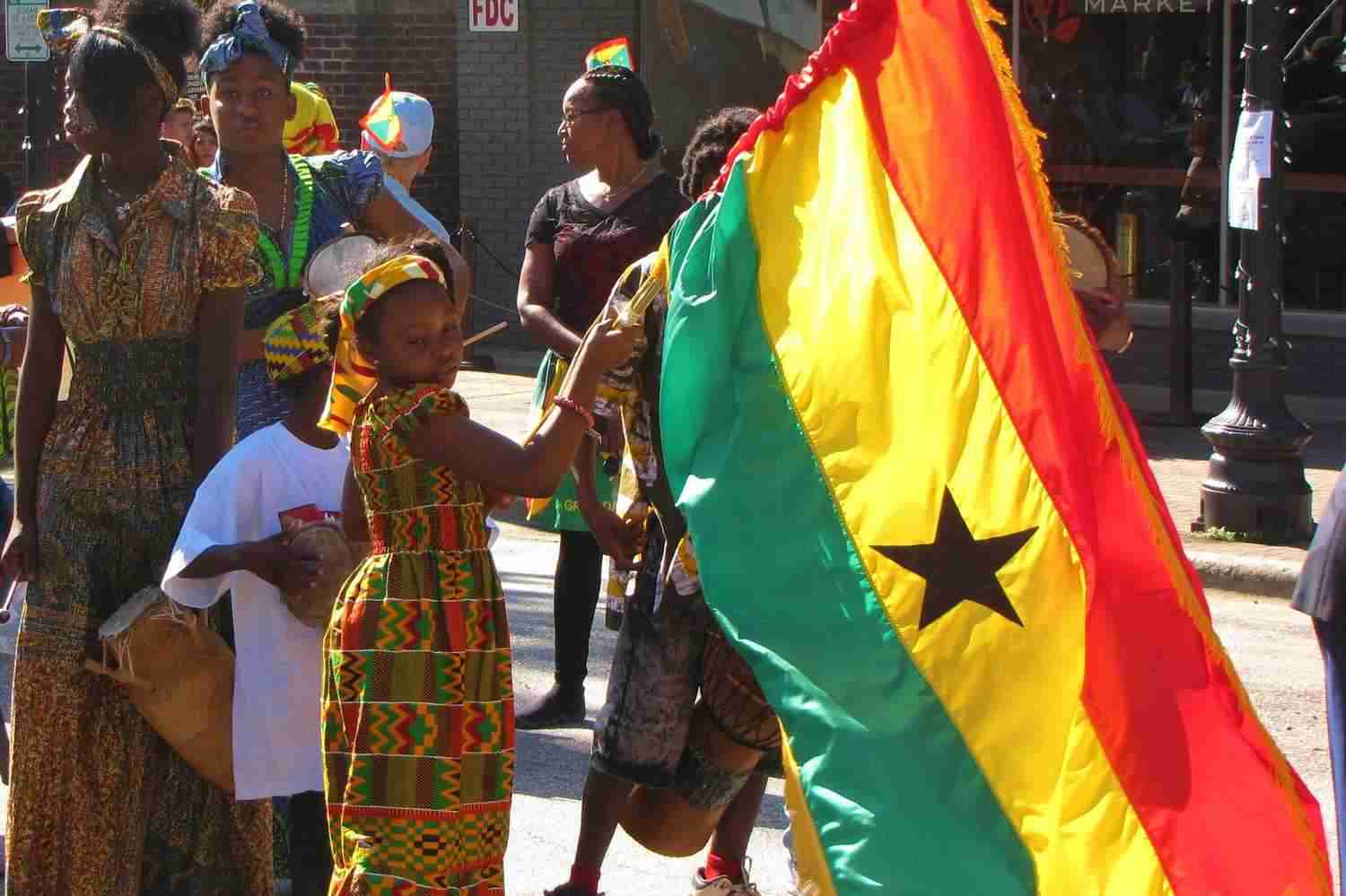 A little girl holding the Ghana Flag 