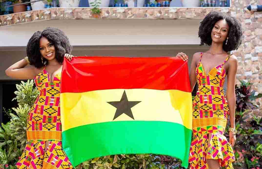 Two beautiful ladies holding the Ghana flag
