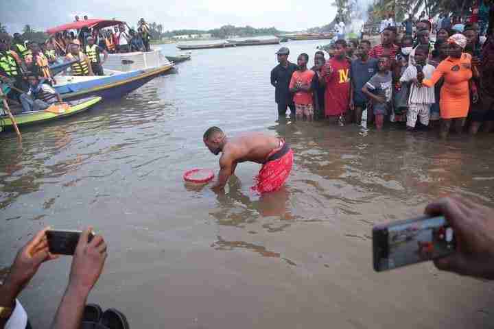 The Ada people at the riverside, performing the traditional ritual