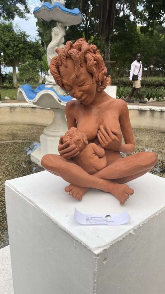 sculpture of a woman breastfeeding her baby 