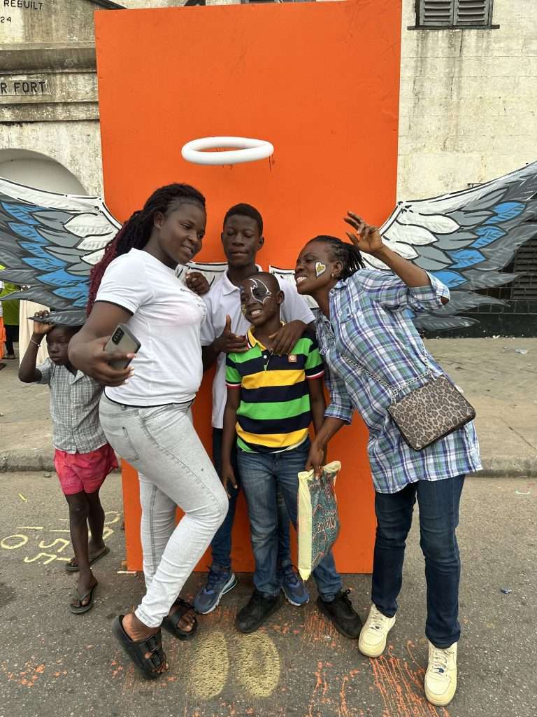 Locals on the street of Accra, taking pictures