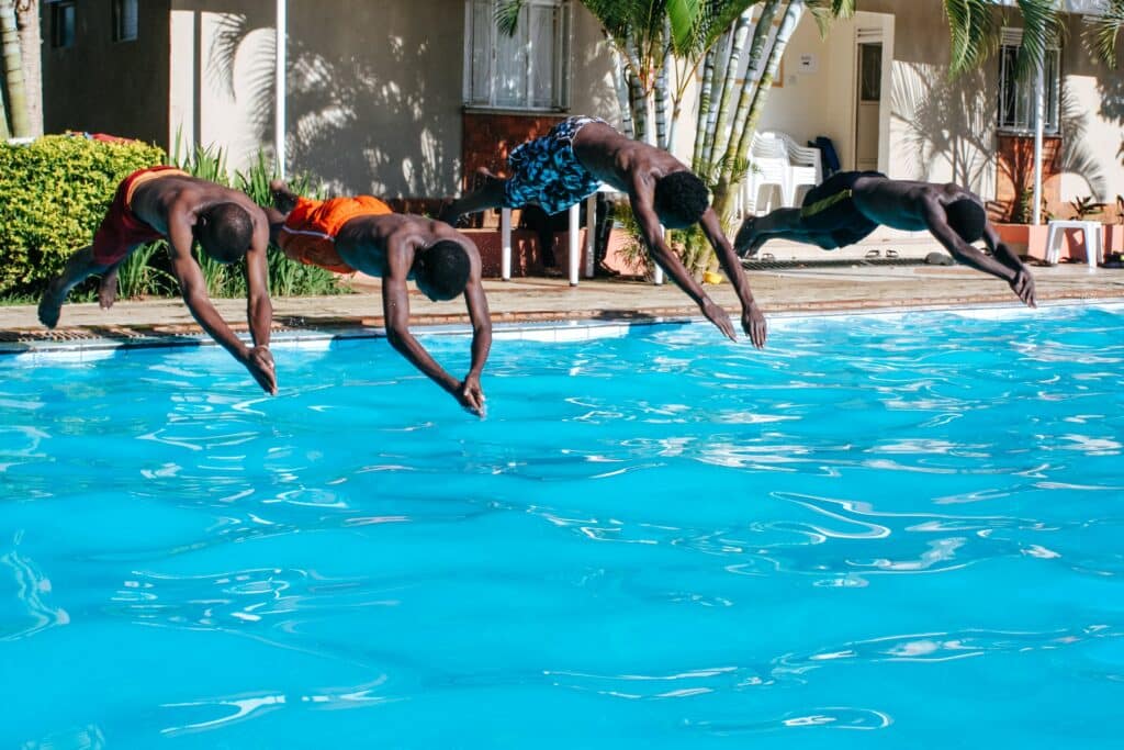 People diving into a pool