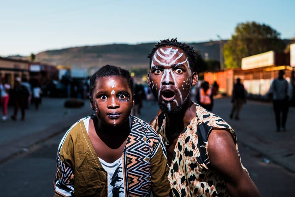 Locals with face paintings in African prints 