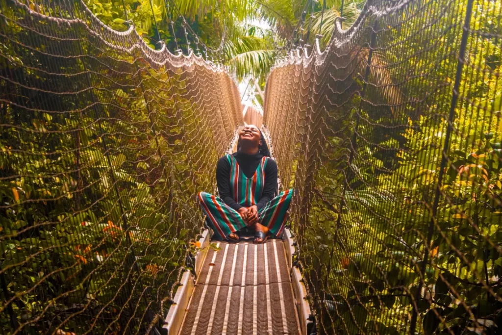 Woman posing for a picture on the canopy walkway